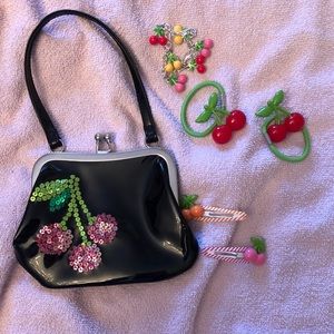 Black purse with cherries.